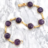 Yellow gold amethyst bracelet with Cabochon cut amethysts.