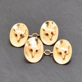 Yellow gold oval concave cufflinks with a fox head with ruby eyes to the centre with ruby eyes.