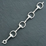 Silver horse bit link bracelet with multiple links and a double chain structure.