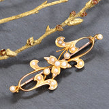 Yellow gold fancy brooch set with seed pearls.