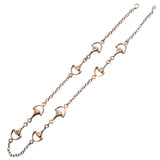 A silver horse bit necklace with a trace link chain and horse bits within the chain, displayed against a white background.