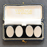 Pair of silver oval chain linked cuff links with one side plain polished silver and the other with an engine turned finish.