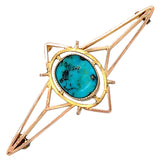 A vintage 9ct rose gold brooch with a central oval matrix turquoise set in a rub over setting.