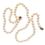 Single row of uniform cultured pearls (Appx 7.75 mm diameter) with a 9ct yellow gold clasp set with pearls with a garnet to the centre. 
