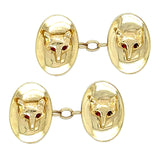 Yellow gold oval concave cufflinks with a fox head with ruby eyes to the centre with ruby eyes.