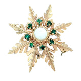 Vintage yellow gold 'star' brooch with a single opal set to the centre surrounded by 8 tsavorite gemstones.