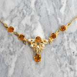 Fancy yellow gold necklace set with six citrine and five pearls.