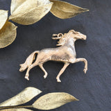 Yellow gold trotting horse pendant.