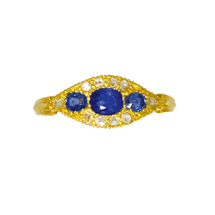 An 18ct yellow gold antique ring featuring three sapphires centre stones surrounded by ten smaller diamonds, hallmarked and dated Chester 1907.