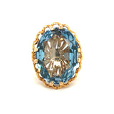 A vintage 9ct yellow gold single synthetic blue stone dress ring with a textured blue stone and gold band, hallmarked and dated 1970.