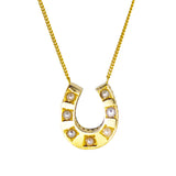 A 9ct gold horse shoe necklace set with seven cultured pearls on a chain.