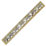 A vintage diamond and pearl brooch with a gold and silver color scheme, featuring alternating rose-cut diamonds and pearls along a bar.