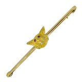 A 14ct gold fox head brooch with ruby eyes set to the centre of a plain bar, featuring a safety catch.