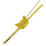 A vintage gold brooch in the shape of a fox head with a textured coat, attached to a safety chain.
