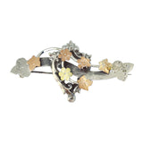 Antique silver flower brooch with rose gold and yellow onlay to the flowers. Fancy edged heart to the centre.