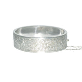 Antique silver bangle with fancy leaf pattern engraved to one half, other half plain. Hallmarked and dated Birmingham UK 1883.