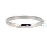 Vintage silver faceted&nbsp;bangle, with safety chain. Hallmarked and dated&nbsp;London&nbsp;1969.