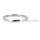 Vintage silver faceted&nbsp;bangle, with safety chain. Hallmarked and dated&nbsp;London&nbsp;1969.