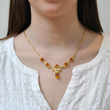 Fancy yellow gold necklace set with six citrine and five pearls.