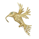 Yellow gold flying bird brooch. A rich textured finish to the body and wings of the bird, with an emerald eye. 